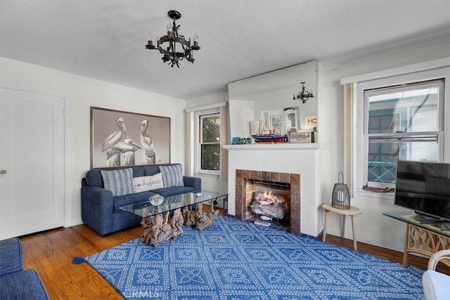 308 Catalina Ave, Avalon, CA 90704 - living area featuring baseboards, a fireplace with flush hearth, an inviting chandelier, and wood finished floors