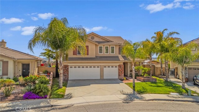 27669 Bluff Vista Way, Menifee, CA 92584 - view of front of property with stucco siding, fence, concrete driveway, a front yard, and an attached garage