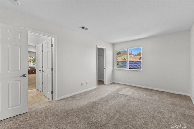 27669 Bluff Vista Way, Menifee, CA 92584 - unfurnished bedroom with visible vents, baseboards, a walk in closet, and carpet