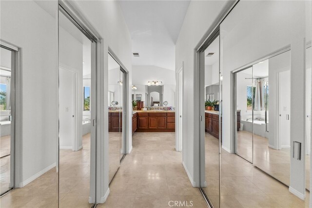 27669 Bluff Vista Way, Menifee, CA 92584 - hallway with light tile patterned flooring, visible vents, and lofted ceiling