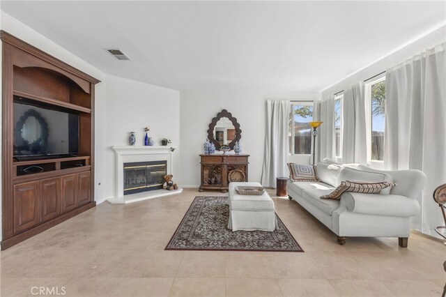 27669 Bluff Vista Way, Menifee, CA 92584 - living room with visible vents and a glass covered fireplace
