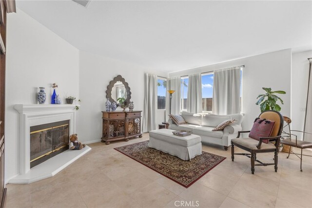 27669 Bluff Vista Way, Menifee, CA 92584 - living room featuring a glass covered fireplace and light tile patterned flooring