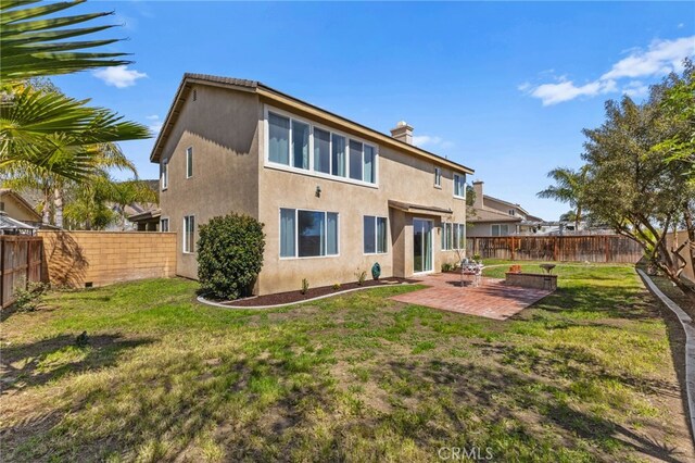 27669 Bluff Vista Way, Menifee, CA 92584 - back of house featuring stucco siding, a patio, a lawn, and a fenced backyard