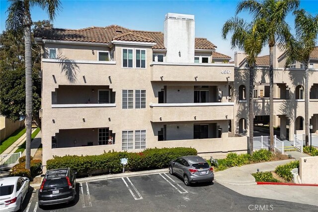 view of property featuring uncovered parking