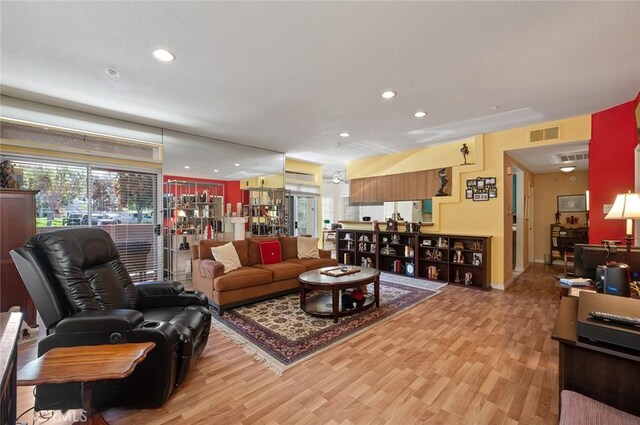4591 Warner Ave Unit 101, Huntington Beach, CA 92649 - living room with light wood finished floors, recessed lighting, and baseboards