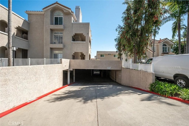 4591 Warner Ave Unit 101, Huntington Beach, CA 92649 - view of parking / parking lot with fence
