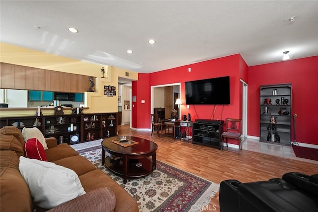 4591 Warner Ave Unit 101, Huntington Beach, CA 92649 - living area with recessed lighting, wood finished floors, and baseboards