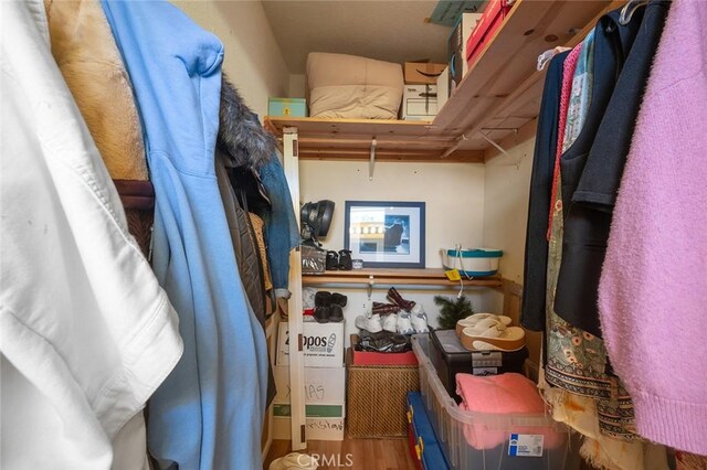 4591 Warner Ave Unit 101, Huntington Beach, CA 92649 - walk in closet featuring wood finished floors