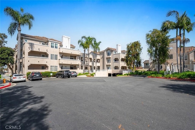 4591 Warner Ave Unit 101, Huntington Beach, CA 92649 - view of building exterior featuring a residential view and uncovered parking