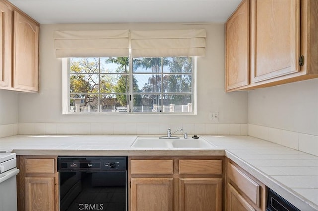 4591 Warner Ave Unit 101, Huntington Beach, CA 92649 - kitchen with black dishwasher, a sink, and tile counters