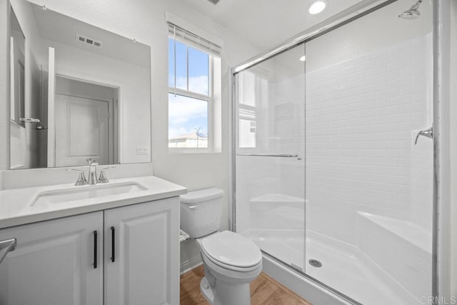 8624 Amherst St, Santee, CA 92071 - full bath featuring wood finished floors, toilet, a stall shower, and vanity