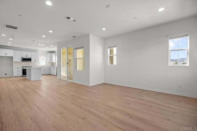 8624 Amherst St, Santee, CA 92071 - unfurnished living room with light wood finished floors, visible vents, recessed lighting, and baseboards