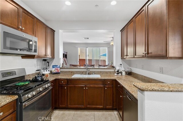 27571 Darrington Ave Unit 2, Murrieta, CA 92562 - kitchen featuring stainless steel appliances, light stone counters, a ceiling fan, light tile patterned flooring, and recessed lighting
