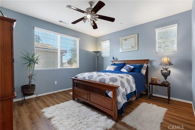 27571 Darrington Ave Unit 2, Murrieta, CA 92562 - bedroom with wood finished floors, multiple windows, and a ceiling fan