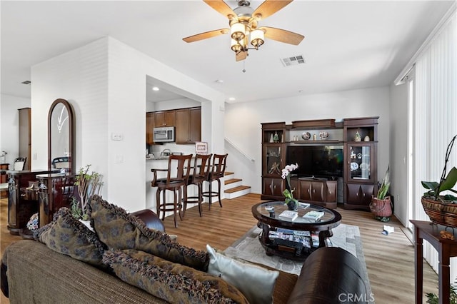 27571 Darrington Ave Unit 2, Murrieta, CA 92562 - living room featuring ceiling fan, light wood-type flooring, and stairway