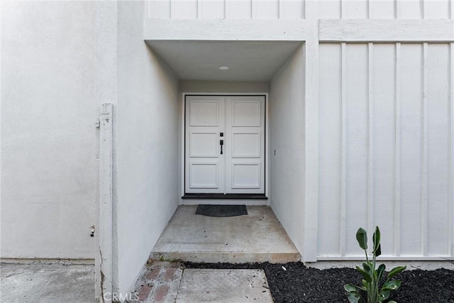 view of exterior entry with board and batten siding