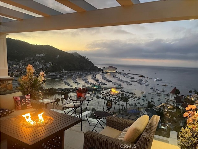 133 Upper Terrace Rd, Avalon, CA 90704 - balcony at dusk with an outdoor fire pit and a water view