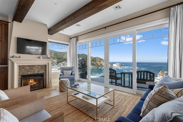 133 Upper Terrace Rd, Avalon, CA 90704 - living area with tile patterned floors, visible vents, a water view, beamed ceiling, and a glass covered fireplace