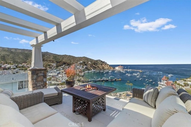 133 Upper Terrace Rd, Avalon, CA 90704 - view of patio with an outdoor living space with a fire pit, a water view, and a pergola