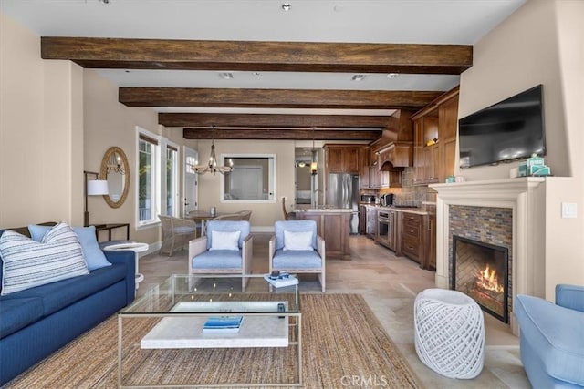 133 Upper Terrace Rd, Avalon, CA 90704 - living room featuring a tiled fireplace, beamed ceiling, baseboards, and an inviting chandelier