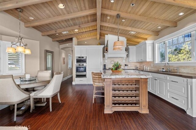 133 Upper Terrace Rd, Avalon, CA 90704 - kitchen with a sink, lofted ceiling with beams, tasteful backsplash, white cabinets, and custom exhaust hood