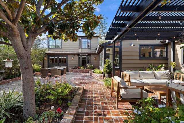 view of patio / terrace with an outdoor hangout area and a pergola