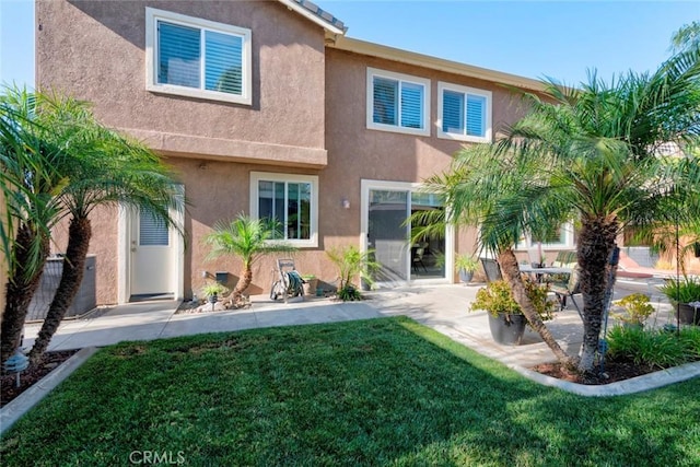 26718 Cactus Creek Way, Menifee, CA 92586 - rear view of house with stucco siding, a patio, and a lawn