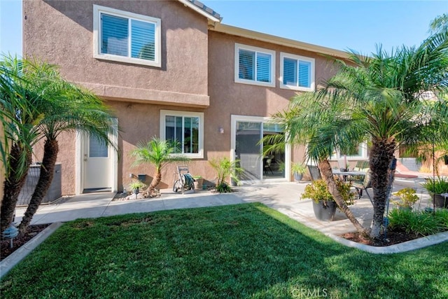 26718 Cactus Creek Way, Menifee, CA 92586 - back of property featuring stucco siding, a patio, and a lawn