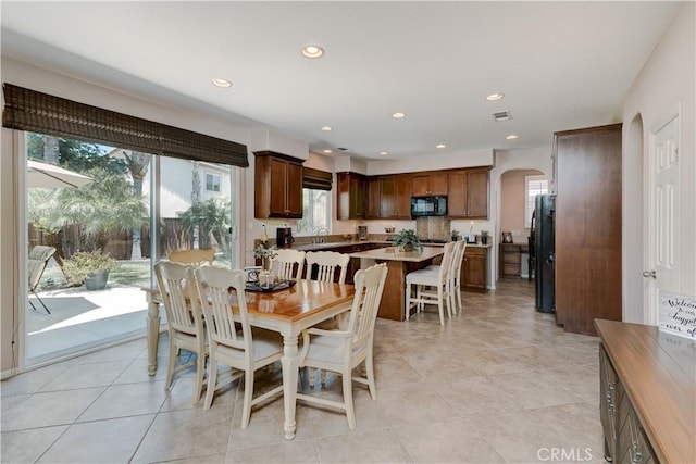 26718 Cactus Creek Way, Menifee, CA 92586 - dining area featuring arched walkways, recessed lighting, and light tile patterned flooring