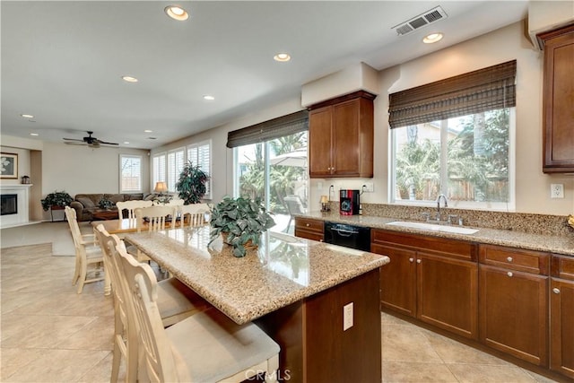 26718 Cactus Creek Way, Menifee, CA 92586 - kitchen featuring a sink, recessed lighting, light stone counters, black dishwasher, and a center island