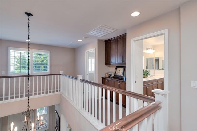 26718 Cactus Creek Way, Menifee, CA 92586 - hallway with plenty of natural light, a chandelier, recessed lighting, and an upstairs landing