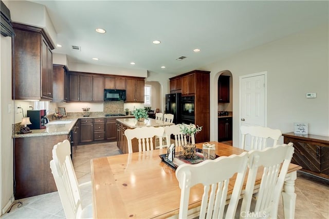 26718 Cactus Creek Way, Menifee, CA 92586 - dining area with arched walkways, light tile patterned floors, and recessed lighting