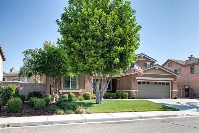 26718 Cactus Creek Way, Menifee, CA 92586 - view of front of property with a garage, stone siding, driveway, and stucco siding