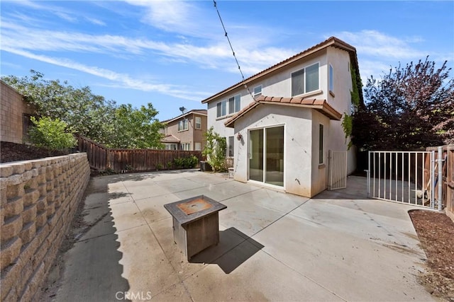 34135 Crenshaw St, Beaumont, CA 92223 - back of house featuring stucco siding, a fenced backyard, a tiled roof, a patio area, and a gate