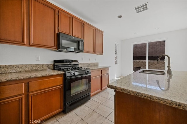 34135 Crenshaw St, Beaumont, CA 92223 - kitchen with black appliances, light tile patterned floors, brown cabinets, light stone countertops, and recessed lighting