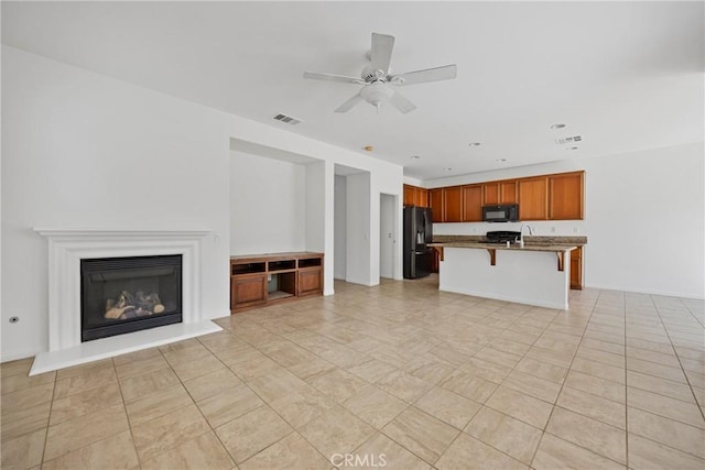34135 Crenshaw St, Beaumont, CA 92223 - unfurnished living room featuring a ceiling fan and a glass covered fireplace