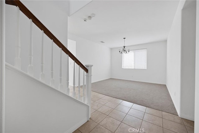 34135 Crenshaw St, Beaumont, CA 92223 - foyer featuring light colored carpet, stairs, a chandelier, and light tile patterned flooring