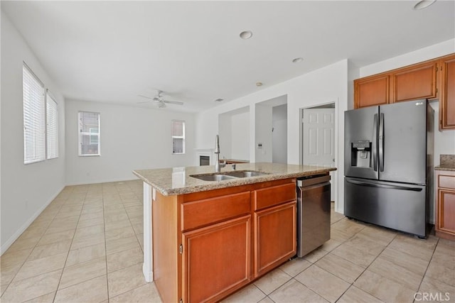 34135 Crenshaw St, Beaumont, CA 92223 - kitchen featuring stainless steel appliances, ceiling fan, light tile patterned flooring, an island with sink, and light stone countertops