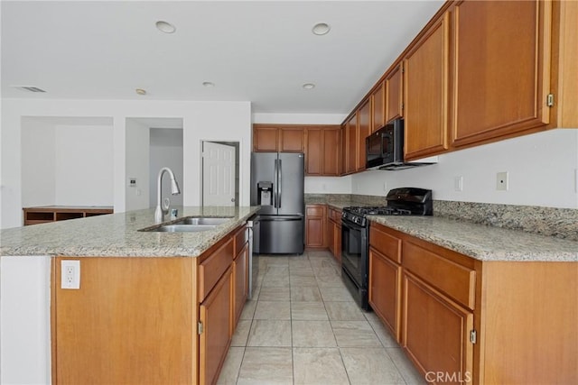 34135 Crenshaw St, Beaumont, CA 92223 - kitchen featuring black appliances, a center island with sink, light stone countertops, brown cabinets, and recessed lighting