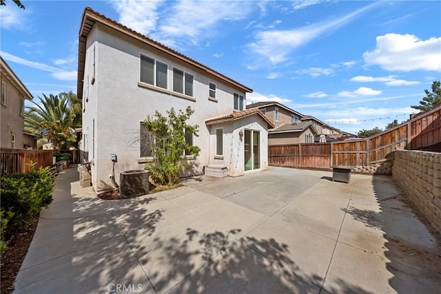 34135 Crenshaw St, Beaumont, CA 92223 - rear view of house with stucco siding, a tiled roof, a patio area, and a fenced backyard