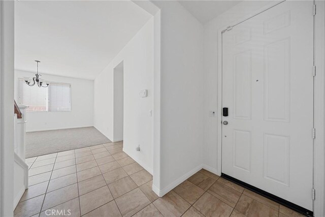 34135 Crenshaw St, Beaumont, CA 92223 - foyer entrance featuring a chandelier, light tile patterned floors, and light carpet