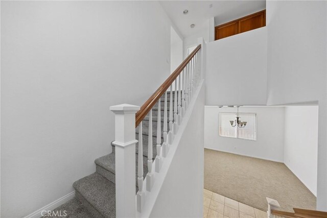 34135 Crenshaw St, Beaumont, CA 92223 - stairs featuring carpet floors, a chandelier, and a high ceiling