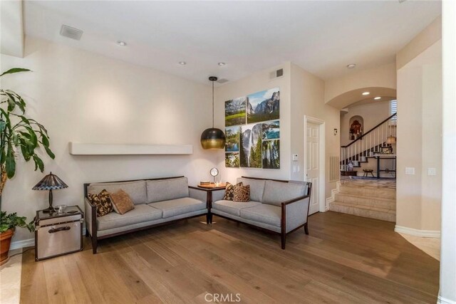 25908 Coleridge Pl, Stevenson Ranch, CA 91381 - living area with wood finished floors, arched walkways, stairway, baseboards, and recessed lighting