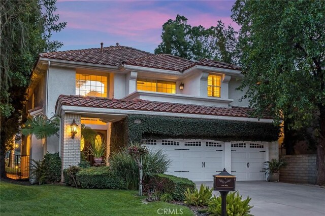 25908 Coleridge Pl, Stevenson Ranch, CA 91381 - mediterranean / spanish house with a tiled roof, an attached garage, driveway, and stucco siding