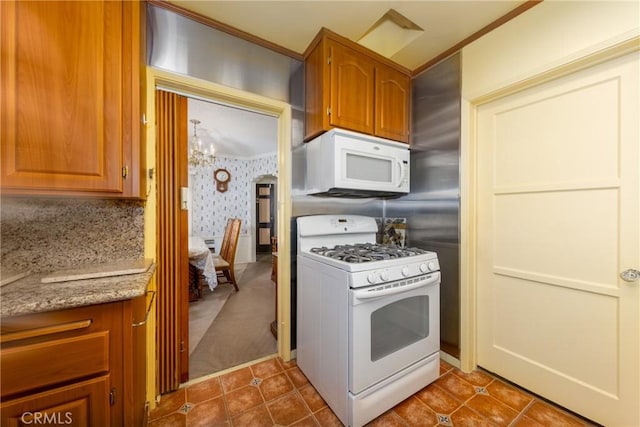 kitchen featuring wallpapered walls, brown cabinets, and white appliances