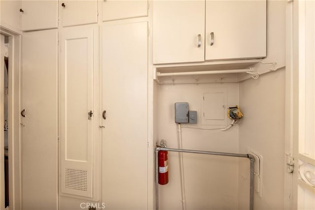 washroom featuring cabinet space and electric panel