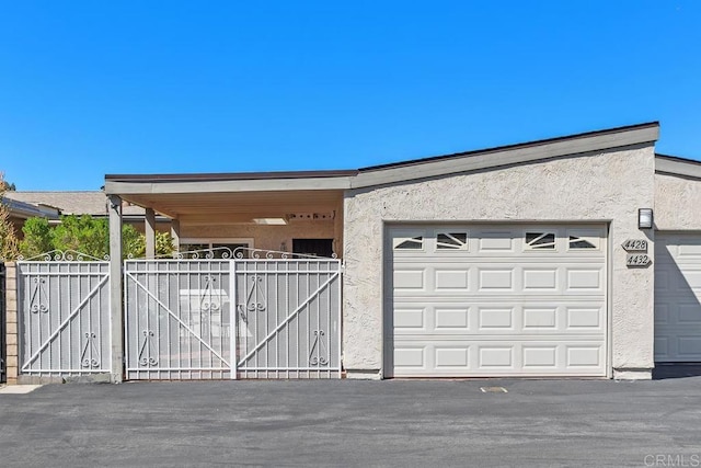 4428 Skimmer Way, Oceanside, CA 92057 - view of side of property with stucco siding, a gate, and a garage