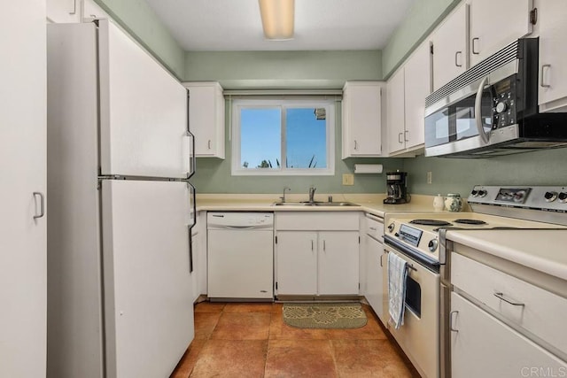 4428 Skimmer Way, Oceanside, CA 92057 - kitchen with white appliances, a sink, white cabinets, and light countertops