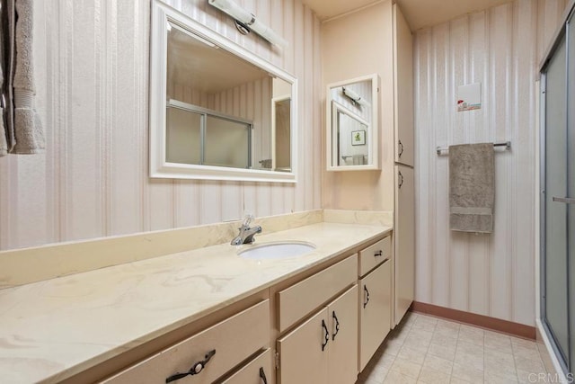 4428 Skimmer Way, Oceanside, CA 92057 - bathroom with wallpapered walls, a stall shower, baseboards, and vanity