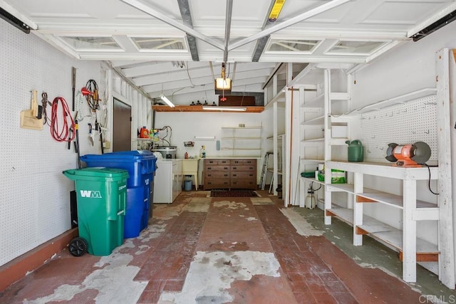 4428 Skimmer Way, Oceanside, CA 92057 - garage featuring a garage door opener, washer / clothes dryer, and a workshop area